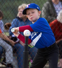 kid hitting t ball